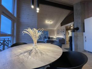 a wooden table with a vase on it in a room at FjordCabin Preikestolen in Strand