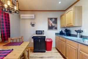 a kitchen with a table and a microwave at Pet Friendly! Couples Retreat in Southern Illinois in Etherton +16 photos