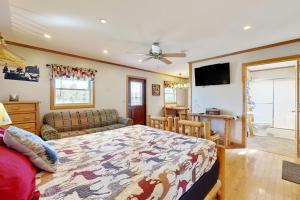 a bedroom with a bed and a couch at Cabin 2: Lakeside in Murphysboro in Etherton