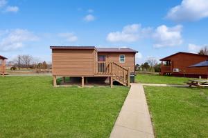 a log cabin with a deck and a picnic table at Cabin 2: Lakeside in Murphysboro in Etherton