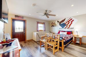 a living room with a bed and a couch at Pet Friendly! Countryside Couples Stay in Illinois in Etherton