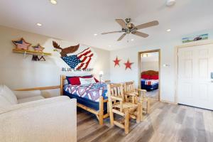 a living room with a bed and a couch at Pet Friendly! Countryside Couples Stay in Illinois in Etherton