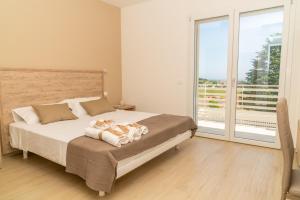 a bedroom with a bed and a sliding glass door at B&B Conero Hermitage in Marcelli