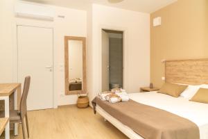 a bedroom with a bed and a desk and a mirror at B&B Conero Hermitage in Marcelli