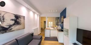 a living room with a couch and a kitchen at NAVA Apartment in the center with private parking of stayinthess in Thessaloniki
