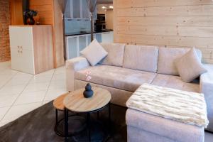 a living room with a couch and a table at Haus Treff in Weissenbach am Lech
