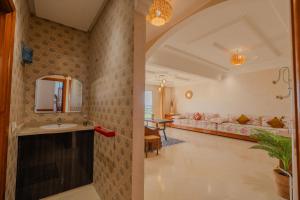 a bathroom with a sink and a couch at appartement chaleureux essaouira in Essaouira +71 photos