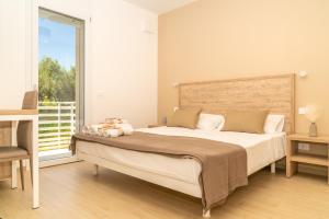 a bedroom with a large bed and a large window at B&B Conero Hermitage in Marcelli