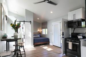 a kitchen with a living room with a table and a couch at North Shore Palms in Mokuleia