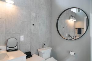a bathroom with a white toilet and a mirror at North Shore Palms in Mokuleia