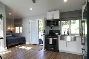 a kitchen with a sink and a stove at North Shore Palms in Mokuleia +5 photos