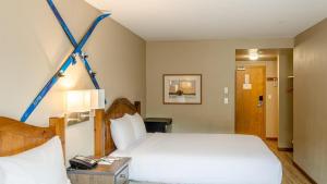 a bedroom with a large white bed with blue arrows on the wall at Cahilty #302 in Sun Peaks