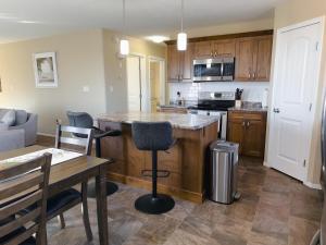 a kitchen with a counter and a table in a room at Spacious 4BR with King Suite - Garage - Netflix in Lloydminster +17 photos