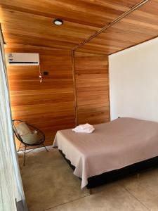 a bedroom with a bed and a chair in it at Sauron Adventure in Cuesta Blanca +65 photos