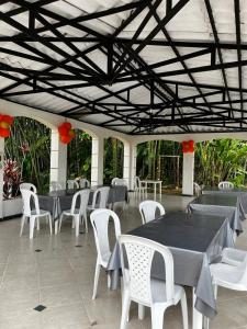 a group of tables and chairs in a patio at mansion cafetera in Quimbaya
