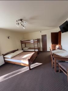 a bedroom with two bunk beds and a table at Willa Fox - Wisła Centrum in Wisła