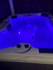 a blue hot tub in a dark room at Willow Place in Mornington