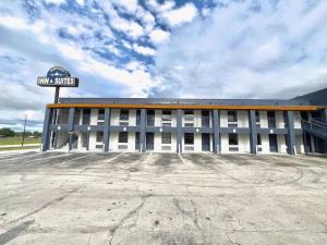 a building with a sign in front of it at Airport Inn in Tulsa