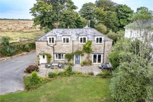 an aerial view of a house with a yard at Wykeham Coach House in Looe