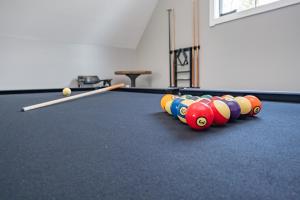 a row of pool balls on a pool table at Whispering Pines by Railey Vacations in McHenry