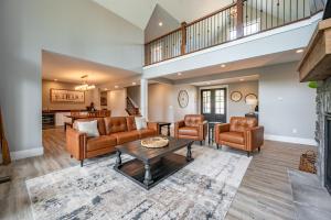 a living room with couches and a table at Whispering Pines by Railey Vacations in McHenry +81 photos