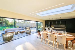 an open living room with a table and chairs and a couch at Wayside Farm in Staveley