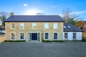 a large brick house with a black roof at Wayside Farm in Staveley