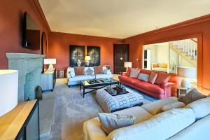 a living room with orange walls and couches at Wayside Farm in Staveley