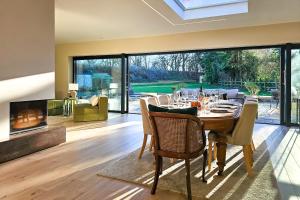 a dining room with a table and a fireplace at Wayside Farm in Staveley