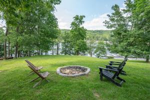 two park benches and a fire pit in a field at Whispering Pines by Railey Vacations in McHenry