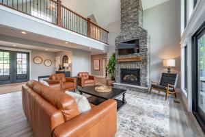 a living room with a couch and a fireplace at Whispering Pines by Railey Vacations in McHenry