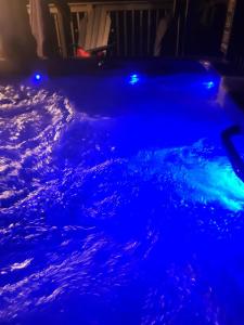 a swimming pool with blue lights in a house at Meadowview Guest House in Hillsboro