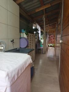 a room with a bed and a tub in it at Casa Flores do Campo in Florianópolis