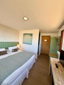 a hotel room with two beds and a television at Hotel Green en Marbella in Maitencillo +39 photos