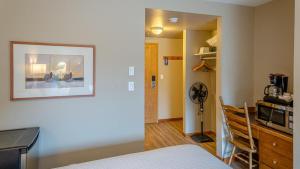 a room with a bed and a kitchen with a microwave at Cahilty #212 home in Sun Peaks