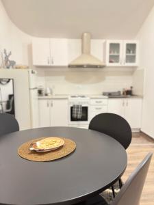 a table with a plate of food on it in a kitchen at Lane Stay Studio in Beograd +7 photos