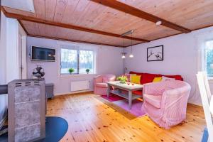 a living room with a couch and a table at KRO863-Virestad-Stubbalycke-4 in Virestad