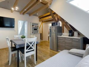 a kitchen and dining room with a table and chairs at Schwanenburg Apartments in Kolonie Röntgental +94 photos