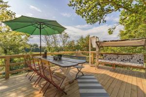 a table with a green umbrella on a deck at BLE849-Ronneby-Rustorpsvaegen-1 in Ronneby +7 photos