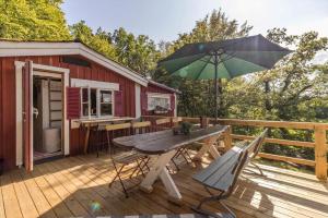 a wooden deck with a table and an umbrella at BLE849-Ronneby-Rustorpsvaegen-1 in Ronneby
