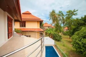 a balcony of a house with a swimming pool at Smile House Villa in Thong Son Beach