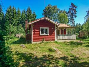 a small red house in the middle of a yard at KRO891-Hallaryd-Kalvshult-8 in Hallaryd