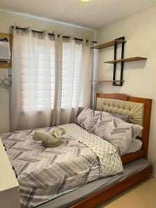 a bedroom with a large bed with a window at The Lotus Suite2 Iloilo in Iloilo City +16 photos