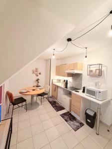 a kitchen and dining room with a table and chairs at Refuge idéal in Digoin +10 photos