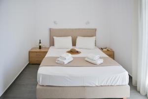 a bedroom with a bed with towels on it at Agros Estate in Plaka