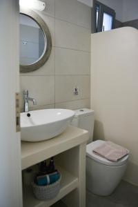 a bathroom with a sink and a toilet at Agros Estate in Plaka +10 photos