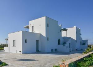a white house with two floors at Agros Estate in Plaka