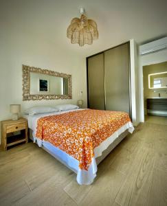 a bedroom with a large bed and a mirror at White Sand Villa - infinity pool in Paea +26 photos