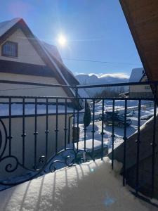 a balcony with a view of a snow covered parking lot at Domek Zakopane Folk Chalet in Zakopane