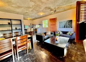 a living room with a couch and a table at Hostal Luz Del Valle in Santa Bárbara de Samaná +43 photos